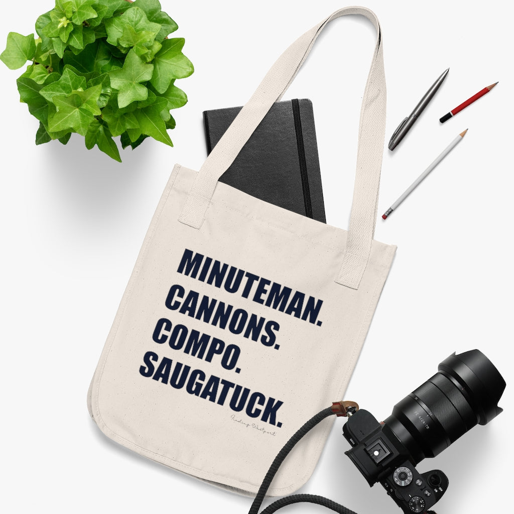 Minuteman. Cannons. Compo. Saugatuck. Organic Canvas Tote Bag  How do you say Westport without saying Westport? Westport, Connecticut is filled with unique aspects. Each providing different elements that make up the town from historic to modern traditions. Minuteman. Cannons. Compo. Saugatuck. You know its Westport.   Proceeds of this collection goes to help build Finding Westport and Finding Connecticut's  brands. 